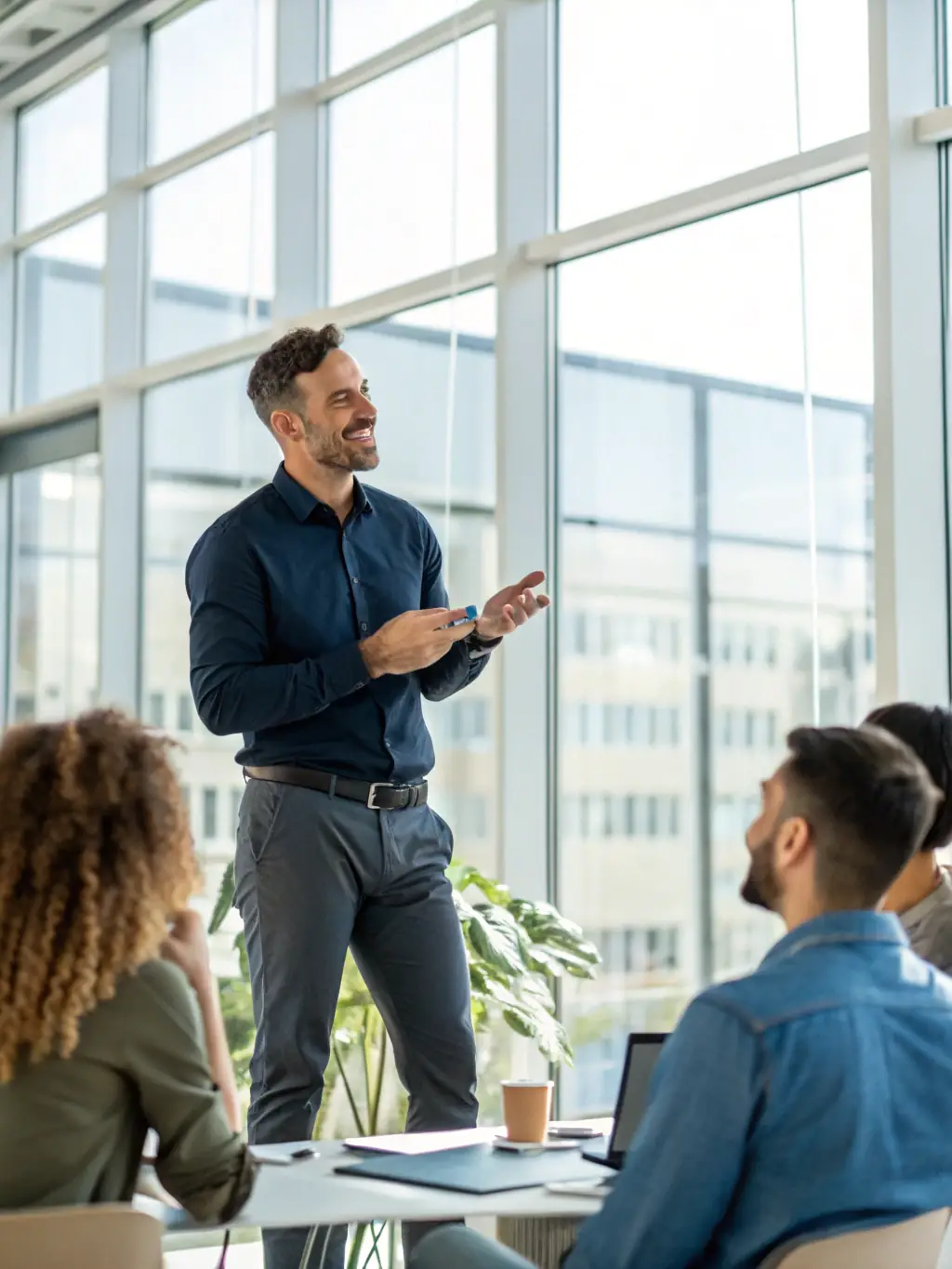 A photo of a man confidently leading a meeting at work, with colleagues engaged and attentive. He exudes leadership and charisma.